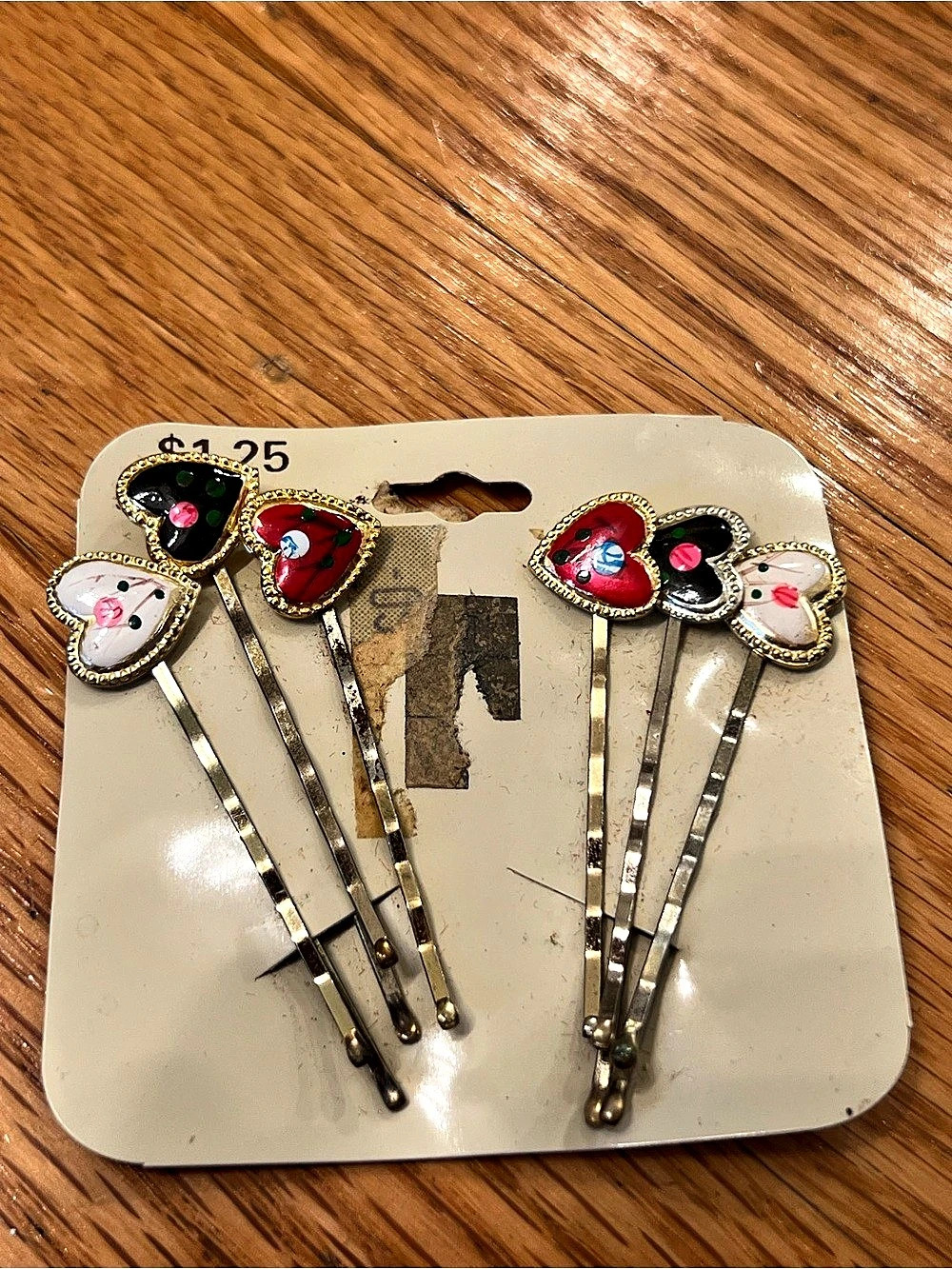 set of vintage-style gains painted heart-themed bobby pins on an original card